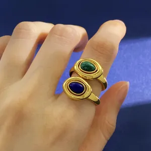 Macro detail of vintage gold rings featuring green malachite and blue oval stone inlays