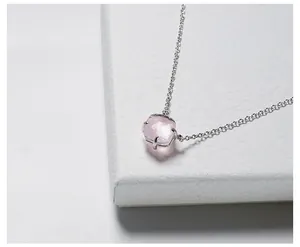 Makroansicht des kissenförmigen rosa Edelsteinanhängers mit silberner Vier-Krallen-Kette
