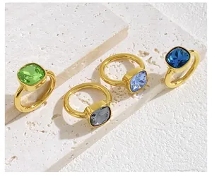 Macro shot of geometric crystal rings in green, blue, and gray with golden bands