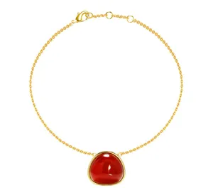 Detail of gold titanium steel bracelet with red agate pendant and lobster clasp closure
