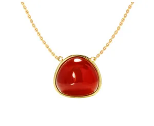 Detailed macro of a triangle red gemstone pendant necklace with golden bezel setting