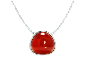 Detailed close-up of a geometric triangle pendant with a vibrant red gemstone inlay