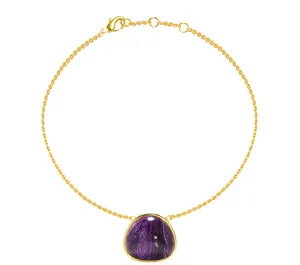 Detail of gold titanium steel bracelet with a purple marbled triangle pendant and clasp
