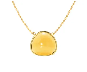 Detailed macro view of a vintage triangular yellow gemstone pendant with a gold chain