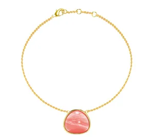 Detail of gold titanium steel bracelet with pink stone pendant and lobster clasp