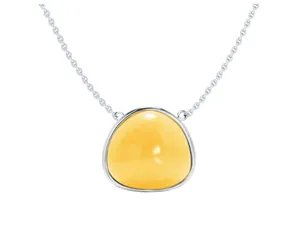 Macro shot of silver triangle pendant with yellow gemstone and delicate chain link
