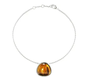 Macro shot of silver titanium chain bracelet with triangular tiger eye stone pendant