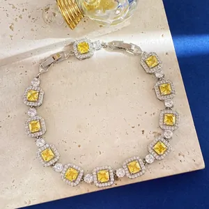 Nahaufnahme von Silberarmband mit gelben Kristallen im Quadratschliff und Zirkonia-Besatz