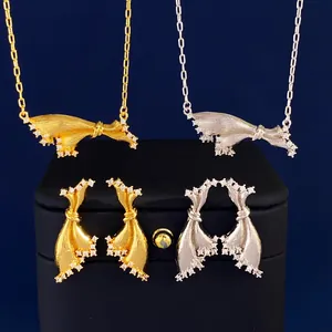 Detailed macro view of brushed gold and silver ribbon necklaces with micro diamond inlay