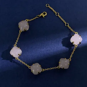 Detail of five cushion-cut pink crystals on a delicate gold chain bracelet with lobster clasp
