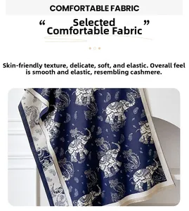 Detail of navy cashmere-like scarf showing white elephant paisley patterns and fringe trim