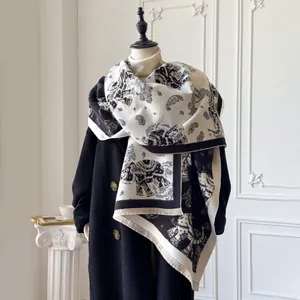 Detail of black and white double-sided jacquard elephant scarf with fine tassel fringe