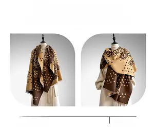 Detailed close-up of thick leopard and polka dot print shawl with soft fringe trim