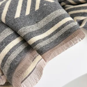 Thick autumn cashmere scarf with grey geometric stripes and fine fringe details