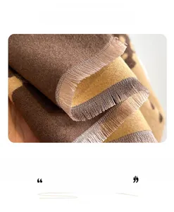 Macro view of bicolor winter scarf showing thick knitted texture and fringe detail