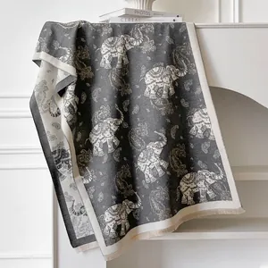 Detailed view of elephant jacquard scarf with tassels on a minimalist mantle