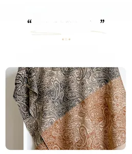 Detailed texture of paisley pattern on orange and grey cashmere-like pashmina shawl