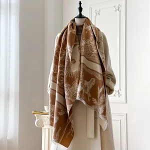 Detail of pashmina scarf with giraffe and lion patterns on an elegant mannequin