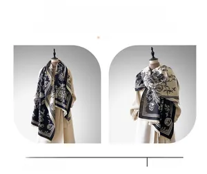 Close-up of floral print cashmere-feel shawl with elegant tassels and monochrome design