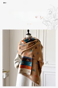 Detail of cashmere-like shawl with bee pattern, decorative stripes and soft fringe edge