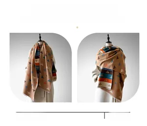 Detail showing versatile thick scarf with bee pattern used as wrap and shawl