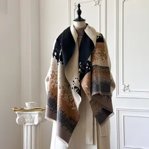 Detail of winter cashmere shawl with abstract ink print and soft fringe edges