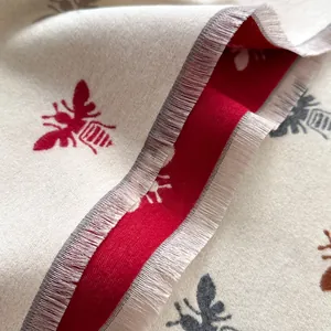 Thick long scarf with double-sided bee pattern and fringe edges in beige and deep red