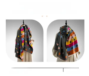 Detail of colorful patchwork heart scarf with soft fringe and thick cashmere-like texture