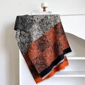 Winter paisley cashmere scarf with orange, cream, and grey block patterns and fringe