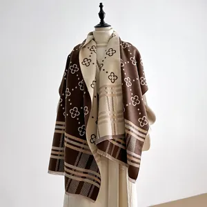 Dual-sided brown cashmere-like scarf with clover pattern and fringe edges on mannequin