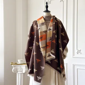 Detail of honeybee pattern and tassel fringe on thick cashmere-like pashmina shawl
