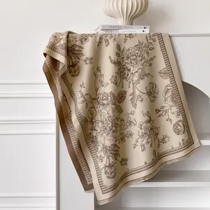 Detail of vintage floral pattern and houndstooth border on beige pashmina scarf