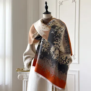 Detail of soft winter scarf with abstract color block patterns and fringe edges