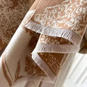 Brown and cream cashmere-feel scarf with artistic tree silhouettes and fringe detailing