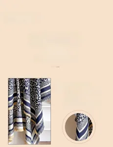 Detail showing high-quality stitching and soft leopard print cashmere texture on scarf