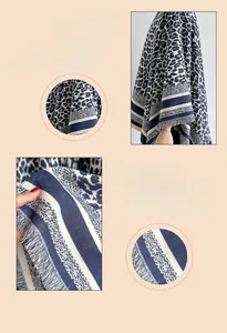 Detail of soft leopard print scarf with tassel edges and blue stripe textured fabric