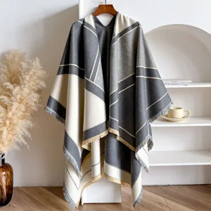 Geometric color-block shawl poncho with fringe detail in gray and beige tones