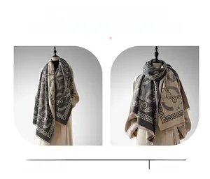 Detail of warm imitation cashmere shawl with geometric jacquard and soft tassels