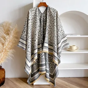 Close-up of leopard print cashmere shawl with fringe hem and yellow contrast border