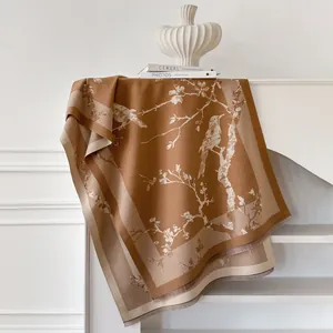 Floral knit shawl with bird pattern and fringe edges in caramel brown and beige