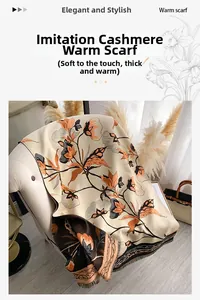 Detail of floral cashmere-like scarf with fringe hanging on an armchair in warm lighting