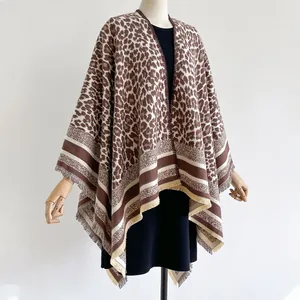 Thick leopard print cashmere shawl for women with elegant fringe trim on a mannequin