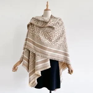 Detail of leopard print scarf with soft cashmere texture and fine fringe trim