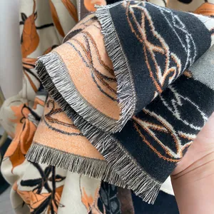 Detail of floral woven shawl with tassels showing thick texture and double-sided pattern