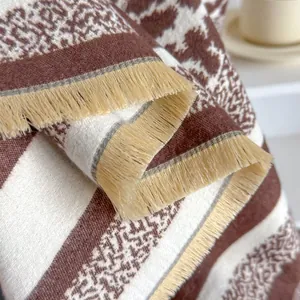 Thick leopard print cashmere scarf with beige tassels for women in a cozy home setting