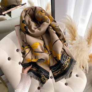 Detailed view of the thick khaki floral shawl with black tassels and soft texture