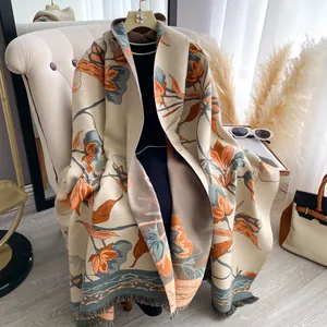 Detailed view of elegant floral pattern and fringe tassels on a thick winter shawl wrap