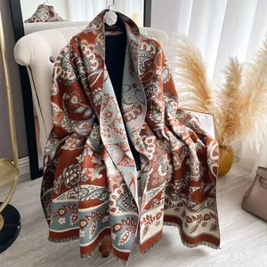 Detail of ethnic paisley shawl with thick fabric texture and delicate fringe trim