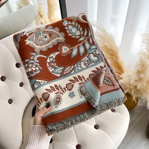 Detail of bohemian paisley shawl with fine fringe edges and soft vintage texture