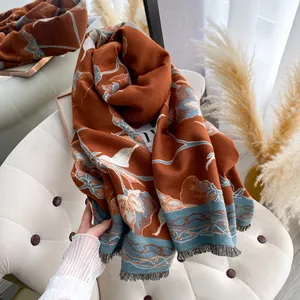 Close-up of floral winter shawl with fringe detailing and warm vintage orange tones